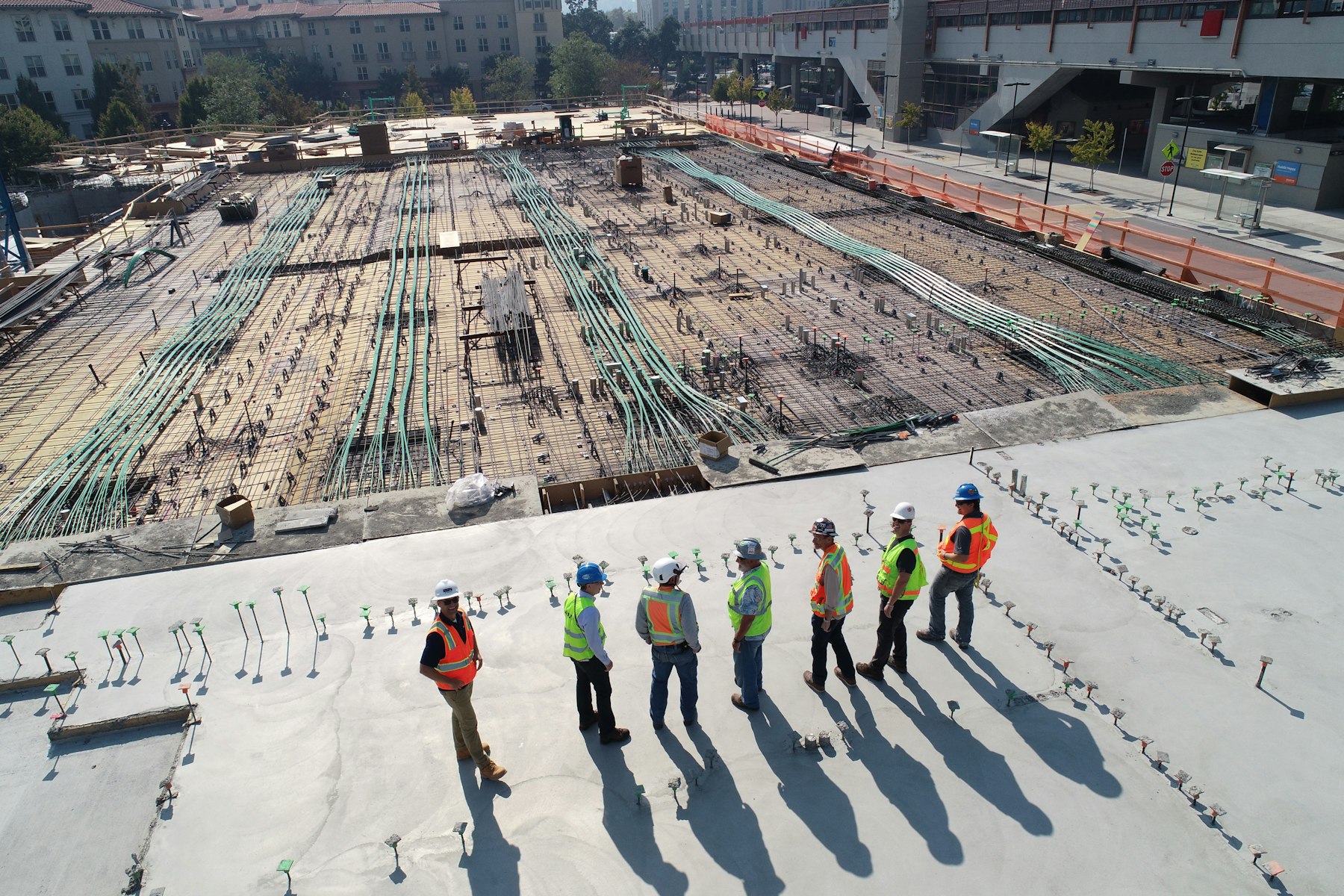 Crew reviewing a reinforced concrete deck on an active construction site